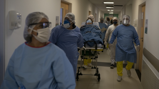 Brazilian medical workers move coronavirus patient