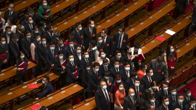 Delegates wait to leave after the closing session of China's National People's Congress