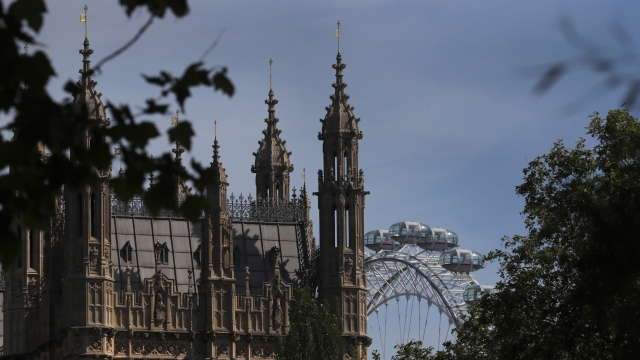 The London Eye stands behind the roof of Parliament in London, Tuesday, June 2, 2020.