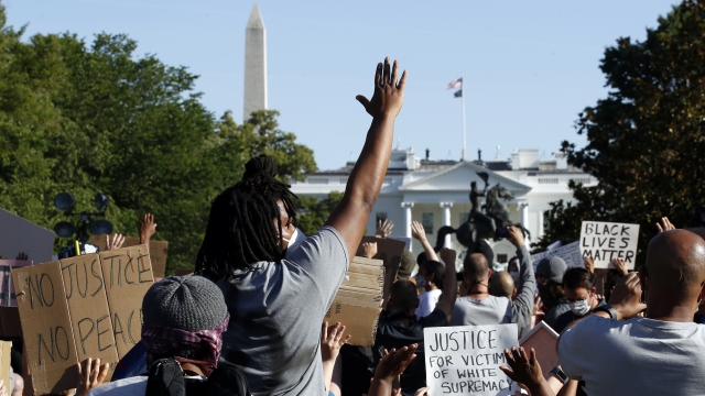 Demonstrators gather in Lafayette Park to protest the death of George Floyd, Monday, June 1, 2020, near the White House.