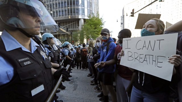 People confront police officers during a protest over the death of George Floyd in Chicago.