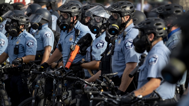 Police gather en masse as protests continue at the Minneapolis 3rd Police Precinct, Wednesday, May 27, 2020, in Minneapolis