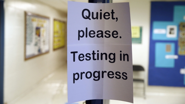 A sign is seen at the entrance to a hall for a college test preparation class.