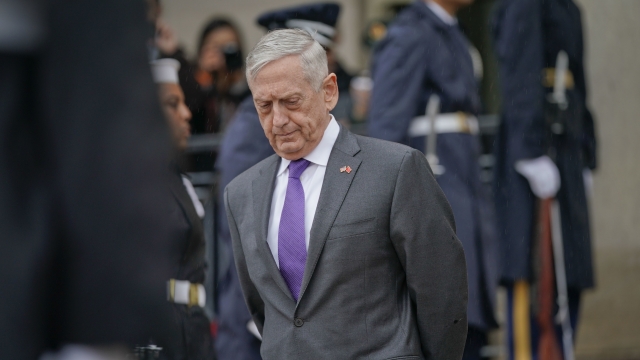 Defense Secretary Jim Mattis waits outside the Pentagon.