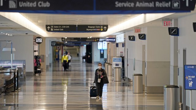 A passenger walks through a terminal at George Bush Intercontinental Airport.