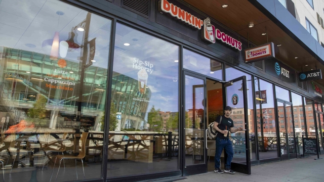 A man walks out of a Dunkin' store