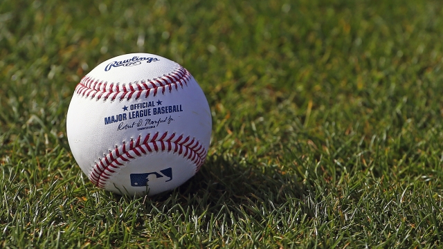 Official MLB baseball shown on a field.