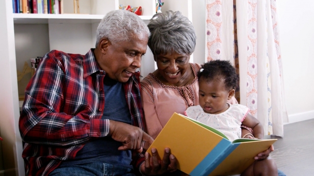 Grandparents read to their grandchild