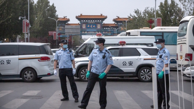 Police in front of the Xinfadi market in Beijing