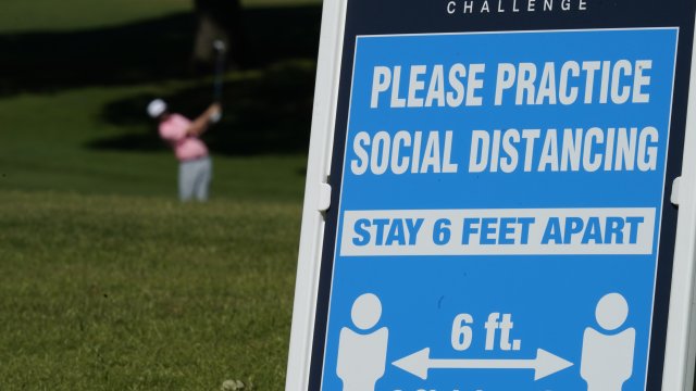 Sign at Colonial Country Club reminds people to practice social distancing