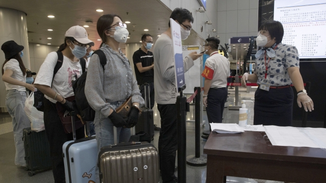 Travelers at a checkpoint at Beijing Capital Airport for passengers from high-risk areas