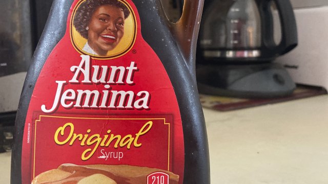 A bottle of Aunt Jemima syrup sits on a counter