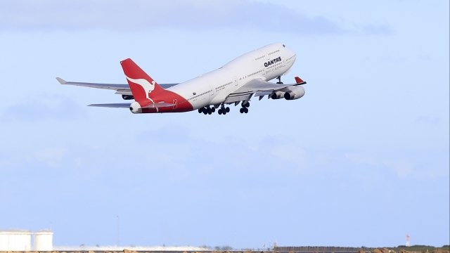 A Qantas jumbo jet lifts off from Sydney Airport