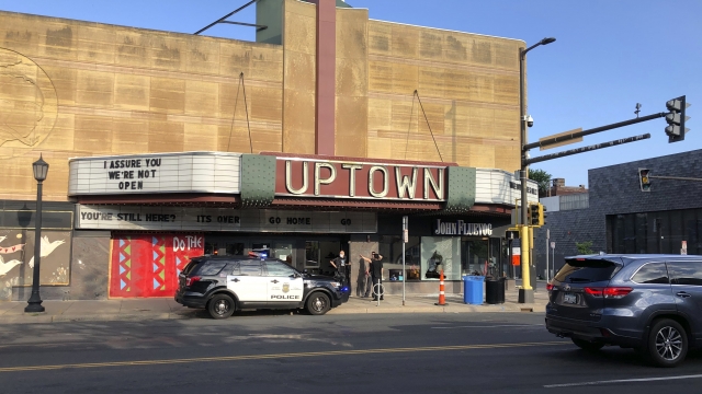 A police vehicle is parked outside the Uptown Theatre Sunday, June 21, 2020, following a shooting