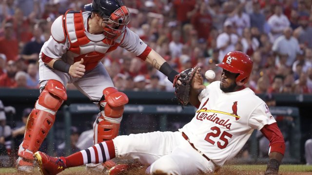 The St. Louis Cardinals' Dexter Fowler scores against the Boston Red Sox