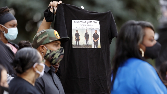 Protesters hold Elijah McClain T-shirt