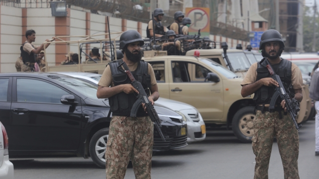 Security personnel surround the Stock Exchange Building after an attack in Karachi, Pakistan