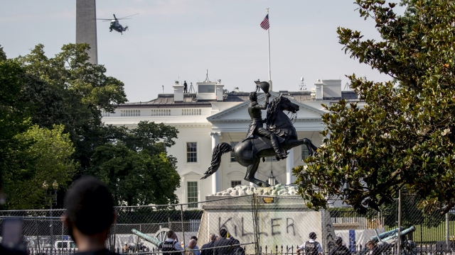 The White House are visible behind a statue of President Andrew Jackson in Lafayette Park.