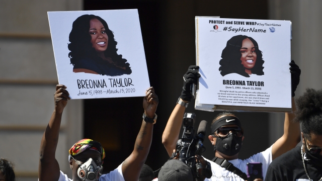 Protesters hold portraits of Breonna Taylor