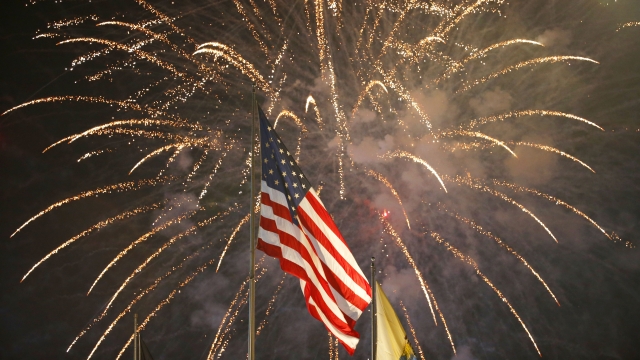 Fireworks explode behind a U.S flag during a July 4th celebration in N.J.