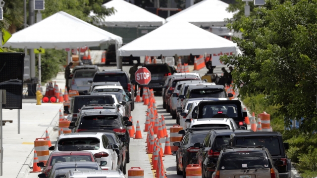 Lines of cars wait at a drive-through coronavirus testing site outside the Miami Beach Convention Center.
