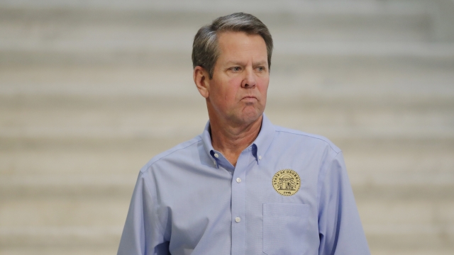 Georgia Gov. Brian Kemp walks away after speaking during a news conference at the state Capitol in Atlanta