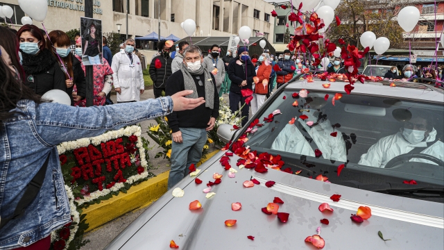 Chilean health workers toss flower petals at funeral for hospital nurse who died of COVID-19.
