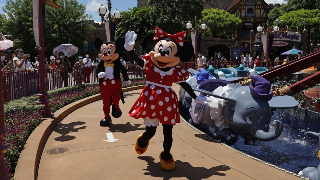 Minnie and Mickey Mouse wave to visitors at the Hong Kong Disneyland