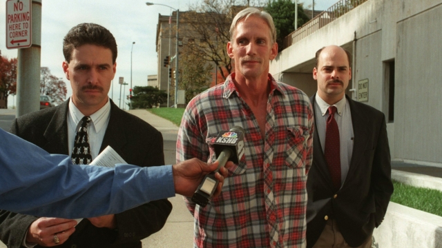 In this 1998 photo, Wesley Ira Purkey, center, is escorted by police officers in Kansas City, Kan., after he was arrested