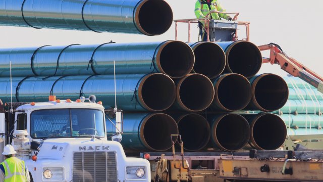 Workers unload pipes in Worthing, S.D., for the Dakota Access oil pipeline.