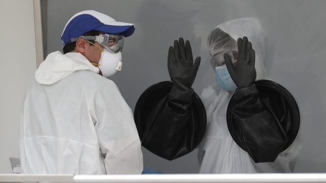Workers at a coronavirus testing site in Florida
