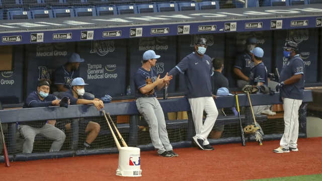 Members of the Tampa Bay Rays await the start of a team baseball scrimmage in St. Petersburg, Fla.