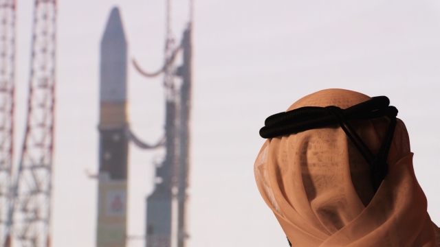 An Emirati man prepares to watch the launch of the "Amal" or "Hope" space probe.