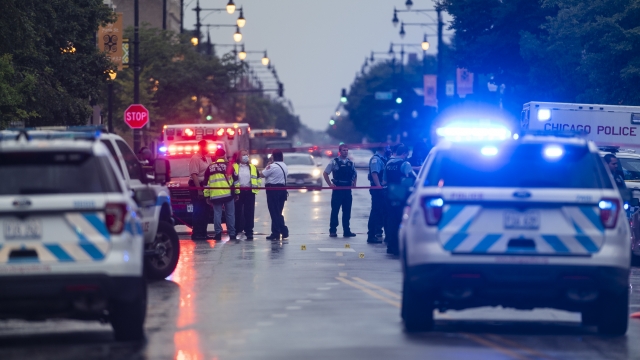 Chicago police investigate the scene of a mass shooting outside a funeral home.
