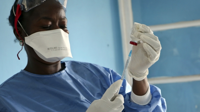 A healthcare worker prepares a vaccine