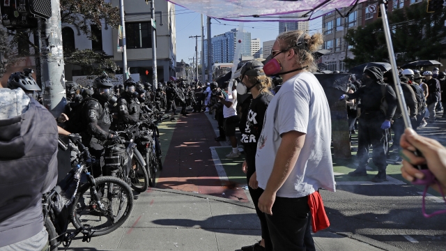 Police square off with protesters Saturday, July 25, 2020, near Seattle Central Community College in Seattle