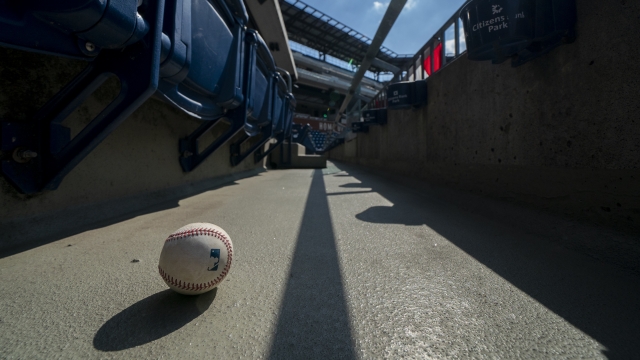 A foul ball sits in the empty stands of a Marlins and Phillies baseball game in Philadelphia.