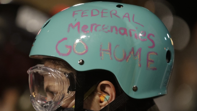 Message on bike helmet protesting federal officers' presence