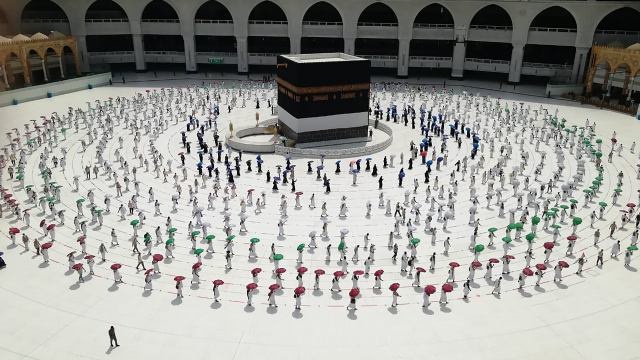Hundreds of Muslim pilgrims circle the Kaaba, the cubic building at the Grand Mosque, as they keep social distancing