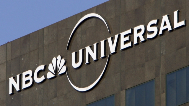 The NBC Universal logo hangs on a building in Los Angeles.