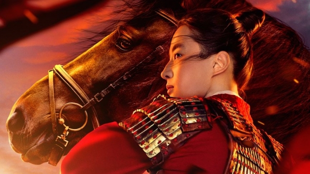 "Mulan" in full armor stands in front of horse.