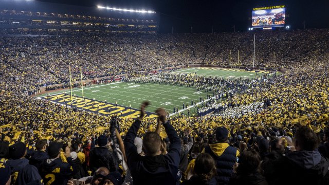 Fans cheer the 2018 University of Michigan Football team as they enter the field
