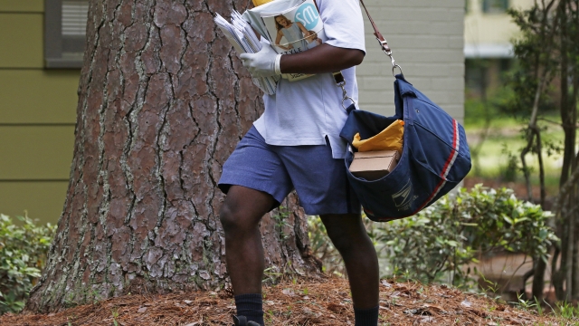 U.S. Postal Service worker delivers mail