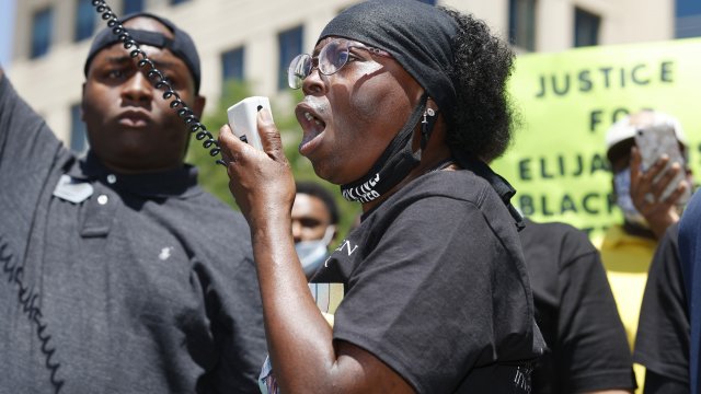 Sheneen McClain speaks during a rally and march over the death of her son, Elijah McClain, outside the police department in A