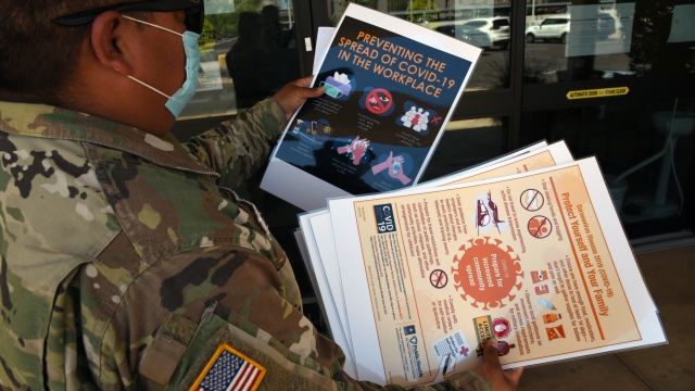 An Arizona National Guard member delivers COVID-19 related posters on Aug. 10, 2020