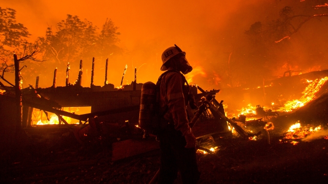 A firefighter watches the Lake Hughes fire consumes a home in Angeles National Forest.