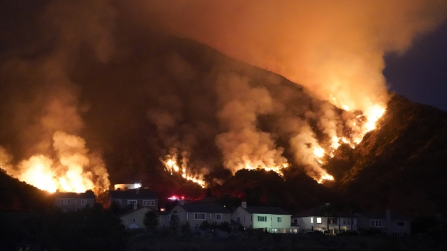 The Ranch Fire burns over a residential area, Thursday, Aug. 13, 2020, in Azusa, Calif.