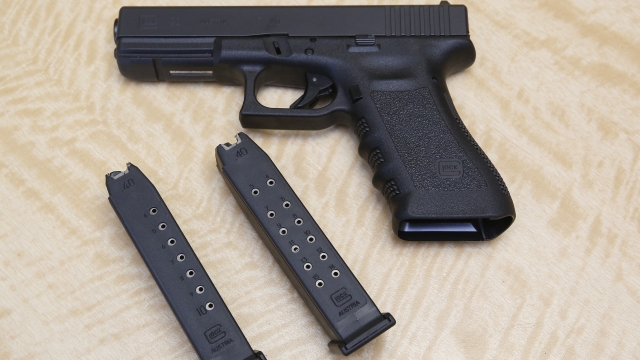 A semi-automatic hand gun with a 10 shot magazine, left, and a 15 shot magazine, right, at a gun store in California.