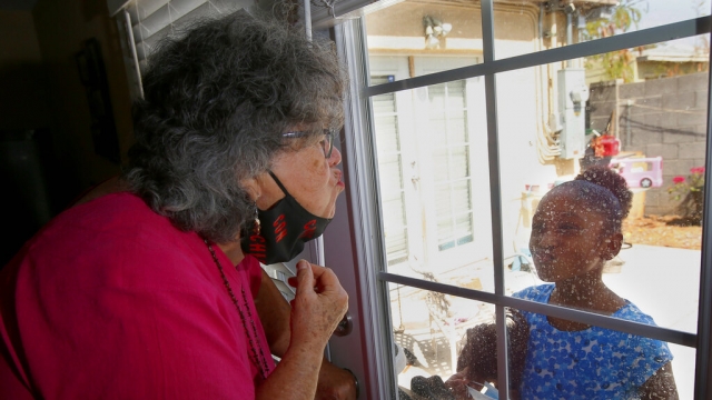 ita Robinson, left, who's 77 and diabetic, blows a kiss to her granddaughter.