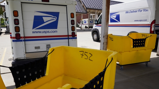 Mail delivery vehicles parked outside of Nebraska  Post Office